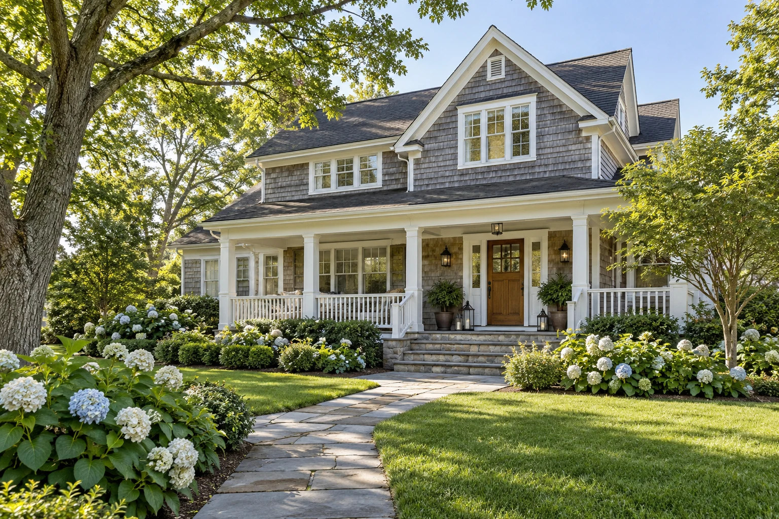Illustrative shingle home with a welcoming porch and a mature garden